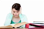 Frustrated teenager doing her homework against white background