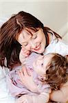 cute baby girl strokes her mother's cheek