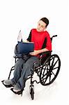 Disabled teen boy doing homework in his wheelchair.  Full body isolated on white.