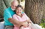 Beautiful senior couple in love, embracing under a tree.