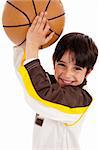 Little kid while throwing the ball while playing the basket ball  on white isolated background,closeup shot