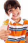 Boy showing the toothbrush on isoalted background