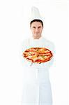 Young male cook smell at pizza with closed eyes against white background