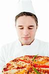 Young male cook smell at pizza with closed eyes against white background