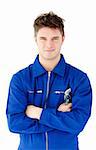 Charismatic mechanic holding tool smiling at the camera against white background