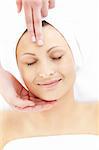 Relaxed  woman enjoying a head massage in a spa center