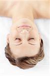 Isolated young woman lying in a spa center with closed eyes