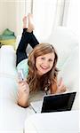 Animated woman with laptop and card on the sofa smiling at the camera at home