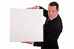 Businessman holding a white board, looking to camera, ioslated on white background