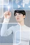 futuristic businesswoman finger touch pad keyboard digital light screen world map