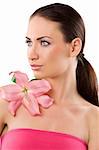 graceful brunette with pink lily looking on one side with her stunning eyes