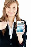 Isolated woman showing at a calculator smiling at the camera