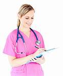 Ambitious female surgeon writing on a clipboard against white background