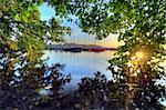 lake with a peek through the leaves to the port