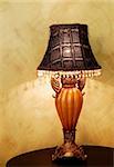 A vintage lamp on a dark wooden table