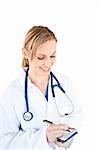 Concentrated female doctor taking notes on her notepad against a white background