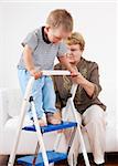 Cute little boy playing with his grandmother and training walking stairs