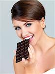 Portrait of beautiful woman, she holding chocolate bar