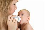 Mother give drink her baby boy by feeding bottle over white