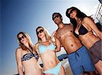 A group of models on the beach against a blue sky