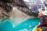 A woman canoeing on Moraine Lake, a tight crop with copy space
