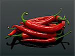 Red chilli peppers isolated against a black background