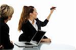 two women during a business meeting with laptop on white background studio