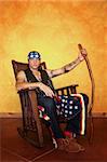 Kneeling Native American man in rocking chair