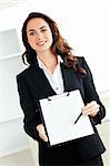 Portrait of a charismatic hispanic businesswoman holding a clipboard against a white background
