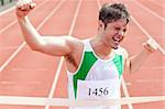 Exulting sprinter showing expression of victory in front of the arrival line in a stadium