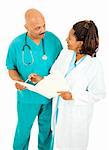 Male and female doctors going over a patient's medical chart.  Isolated on white.