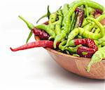 Red and green peppers with wooden plate