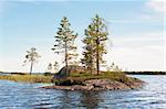 Small rocky island on lake on sunday