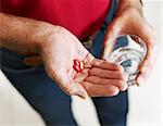 Close up of senior man taking medicines. Horizontal shape, high angle view, Selective focus