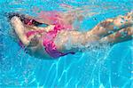 underwater pink bikini little girl swimming in blue pool