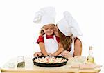 Woman and little girl making pizza together - isolated