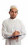Arab mixed race business man wearing traditional middle eastern attire and topi gold embroidered hat.  He is holding a clipboard folder and writing.  White background.