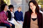 A portrait of a happy young woman with friends