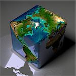 Earth is a cube with translucent water of the oceans and highlights of reflected light on a gray background table