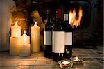WIne Bottles in festive setting with candles and log fire