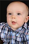 Beautiful caucasian baby boy wearing a blue shirt