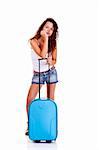 Beautiful young woman with a blue suitcase, isolated on white background