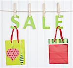 SALE and Holiday Gift Bags on a Clothesline.  Holiday Concept.