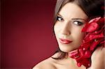 Portrait of the pretty girl with the red petals, isolated