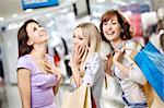 Happy smiling girls in shop with purchases