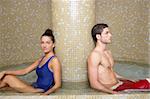 Couple young in cool spa water round pool after sauna therapy