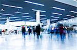 clean tiled floor, reflection of light on floor and blurred view of people walking