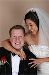 Beautiful Asian and Causian bridal couple on their wedding day