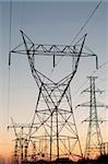 A long line of electrical transmission towers carrying high voltage lines.