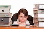 Woman in office with folder stacks is desperate, stressed and over-worked.